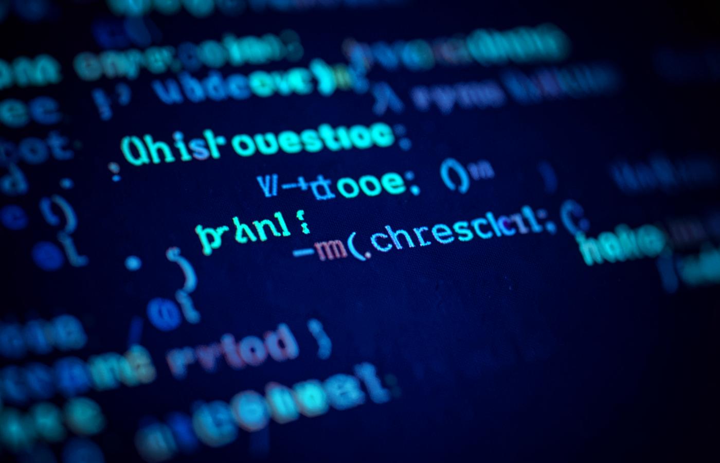 Close-up of source code displayed on a screen with cyan and blue syntax highlighting